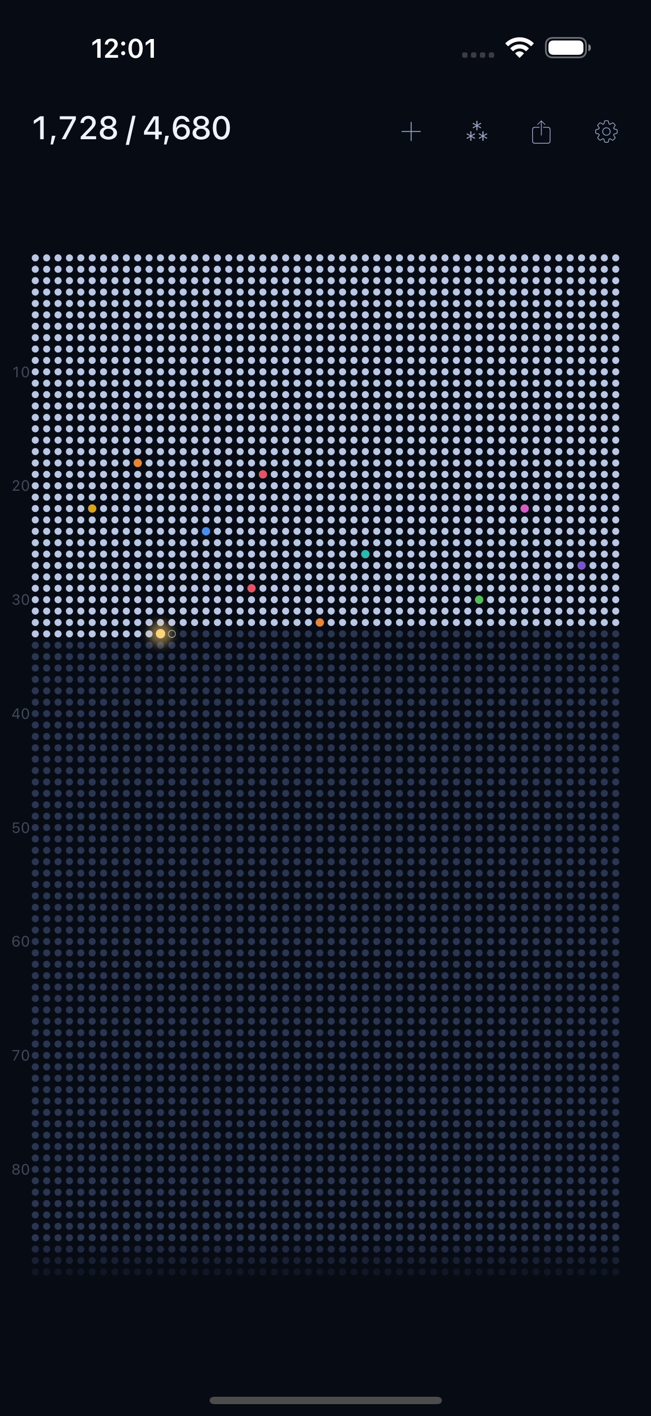 The Asterism life grid on iPhone: a full life drawn as dots on a night-sky background, lived weeks lit, the current week glowing gold